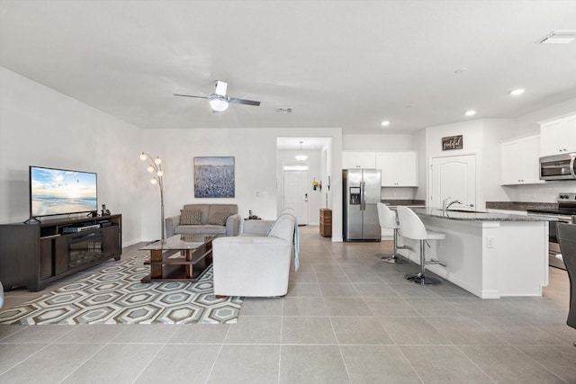 living room featuring recessed lighting, visible vents, ceiling fan, and light tile patterned floors