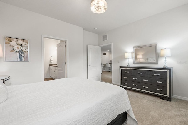 bedroom with light carpet, ensuite bathroom, visible vents, and baseboards