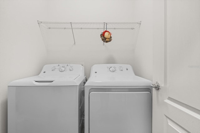 clothes washing area featuring laundry area and washer and dryer