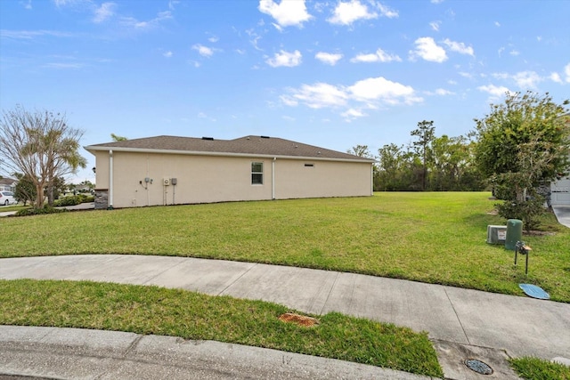 view of home's exterior with a lawn and stucco siding