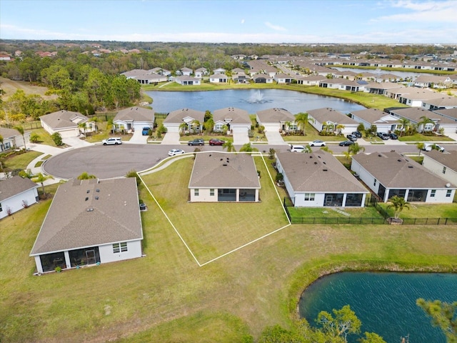 birds eye view of property with a water view and a residential view