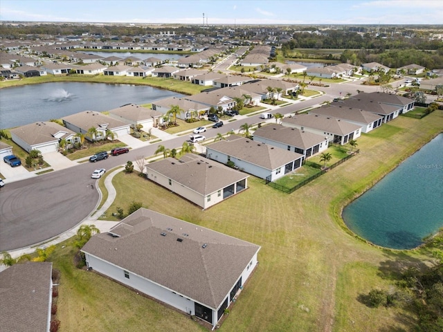 bird's eye view featuring a residential view and a water view