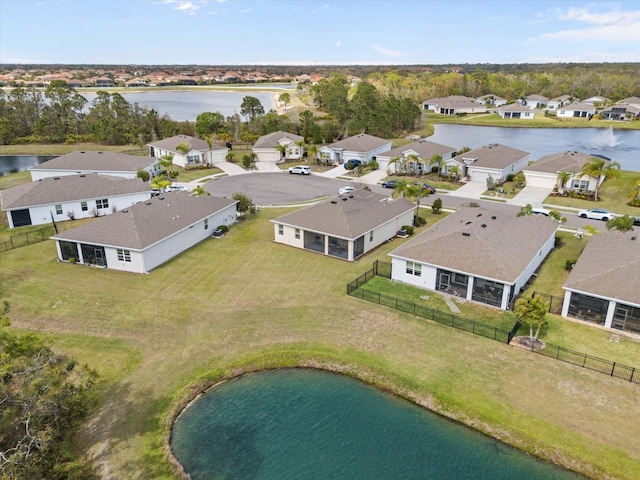 drone / aerial view with a residential view and a water view