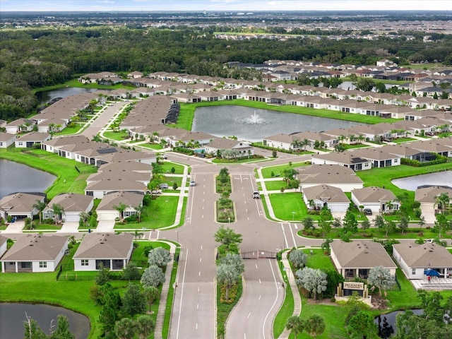 birds eye view of property with a water view and a residential view