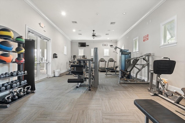 gym featuring plenty of natural light, ornamental molding, carpet, and baseboards