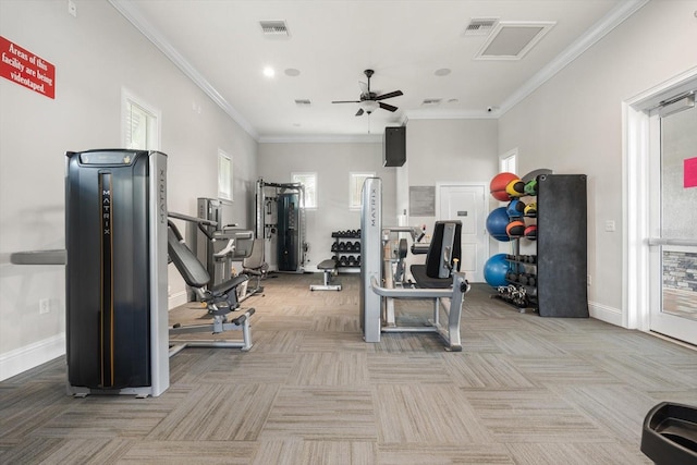 exercise room featuring baseboards, carpet, visible vents, and crown molding