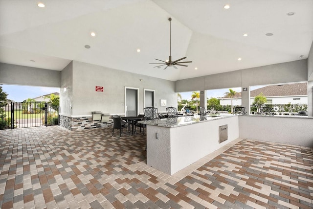 kitchen featuring high vaulted ceiling, open floor plan, a ceiling fan, and recessed lighting