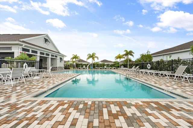 pool featuring fence and a patio