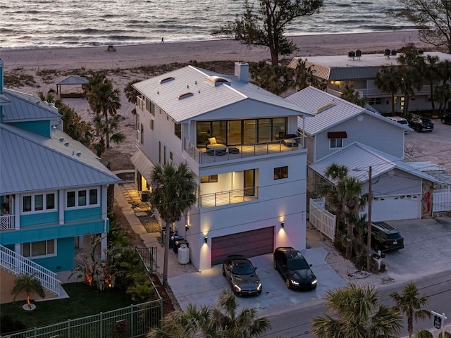 exterior space featuring a water view and a view of the beach