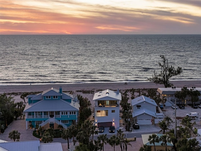 birds eye view of property featuring a water view and a view of the beach