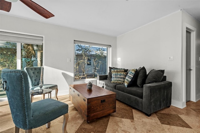 living room featuring ornamental molding, a wealth of natural light, and baseboards