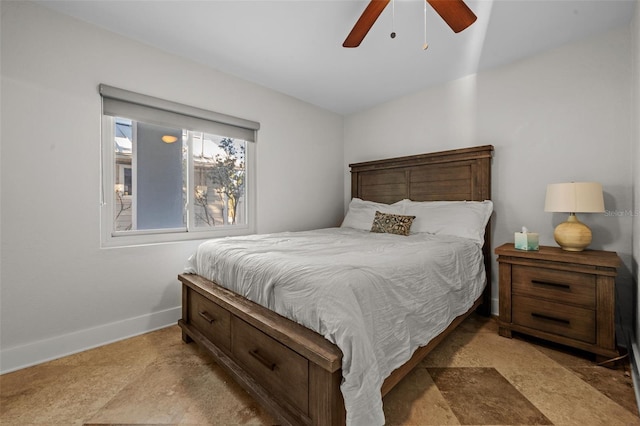 bedroom with a ceiling fan and baseboards