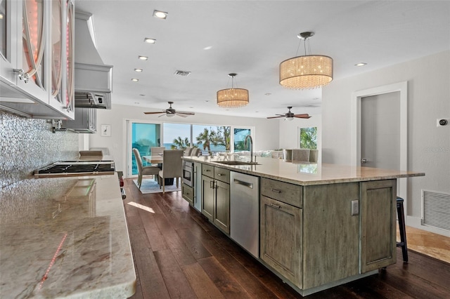 kitchen with stainless steel appliances, dark wood-style flooring, visible vents, and a sink