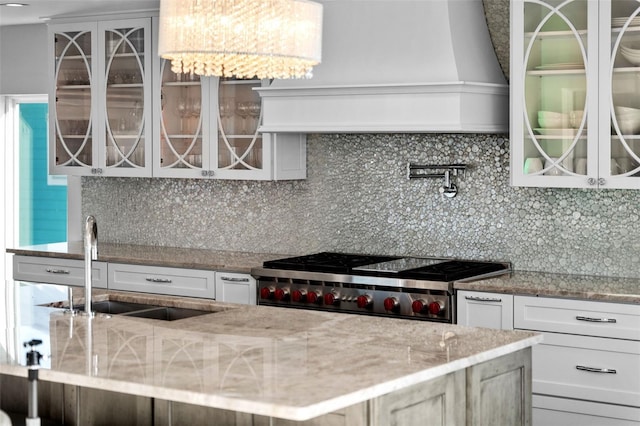 kitchen with glass insert cabinets, decorative backsplash, and stove