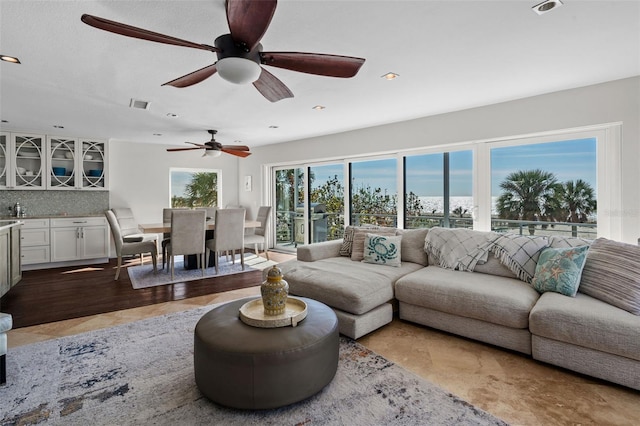 living area featuring visible vents and recessed lighting