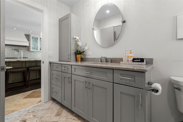 bathroom with recessed lighting, backsplash, toilet, and vanity