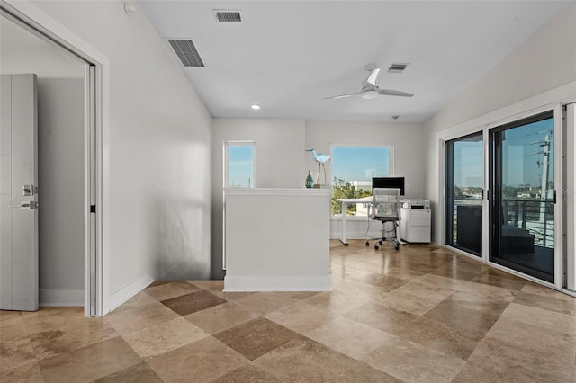 office with baseboards, visible vents, and a ceiling fan