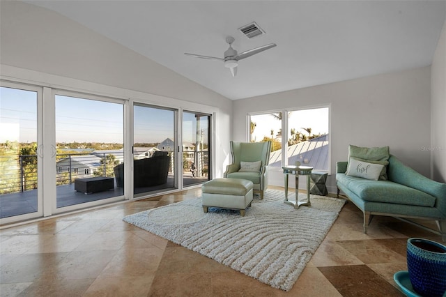 sunroom featuring visible vents, vaulted ceiling, and ceiling fan