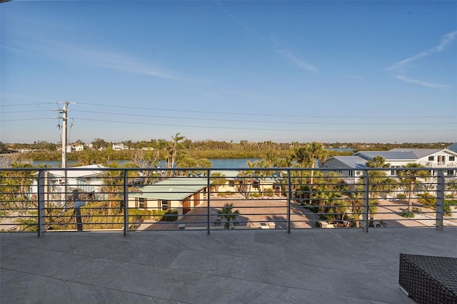 view of patio / terrace featuring a water view and a balcony