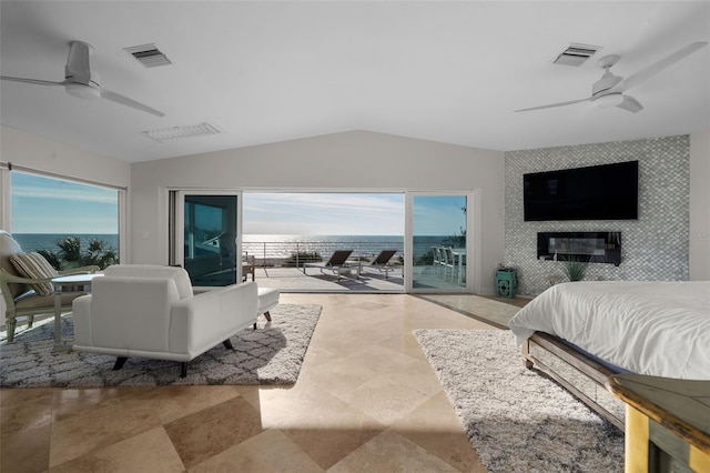 bedroom featuring an accent wall, access to outside, visible vents, and vaulted ceiling