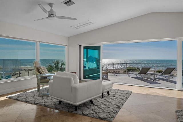 living area featuring a water view, visible vents, a ceiling fan, and lofted ceiling