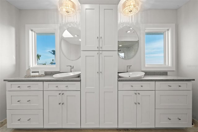 full bath featuring a chandelier and vanity