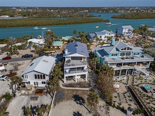 drone / aerial view featuring a water view and a residential view