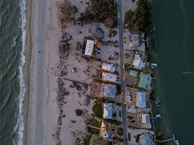 birds eye view of property featuring a water view and a view of the beach