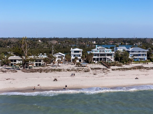 drone / aerial view featuring a water view and a beach view