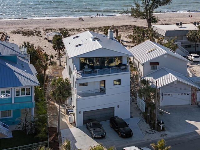 birds eye view of property featuring a water view and a view of the beach