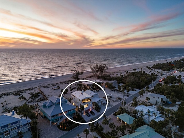 birds eye view of property with a beach view and a water view