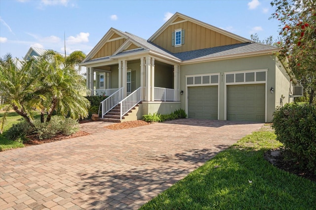 view of front of house featuring decorative driveway, a porch, board and batten siding, an attached garage, and a shingled roof