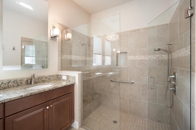 bathroom with vanity and a shower stall