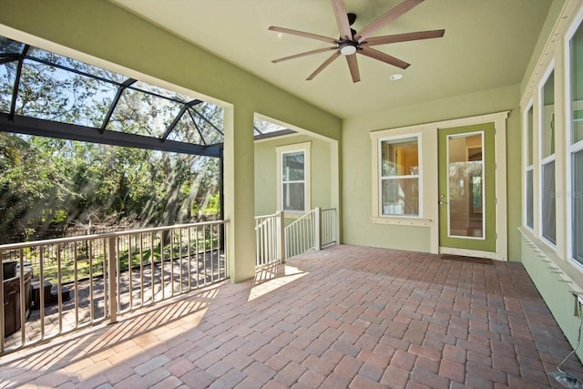 unfurnished sunroom with ceiling fan