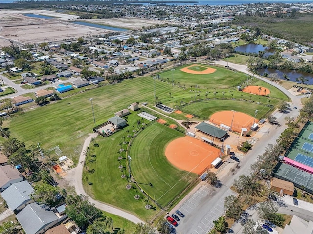 birds eye view of property featuring view of golf course and a water view