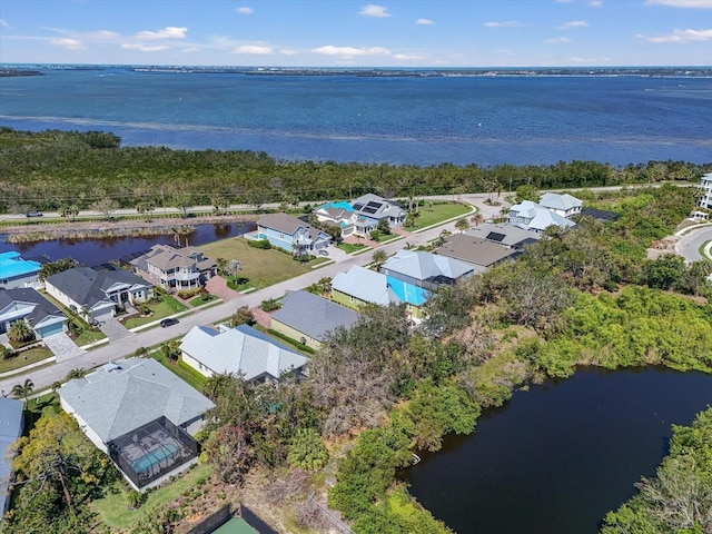 birds eye view of property with a residential view and a water view