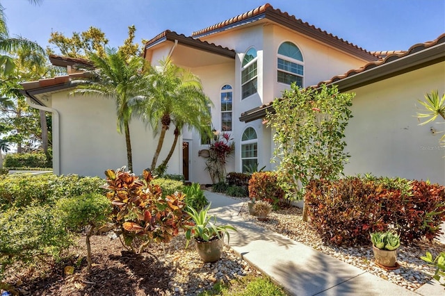 view of front of house with a tile roof and stucco siding