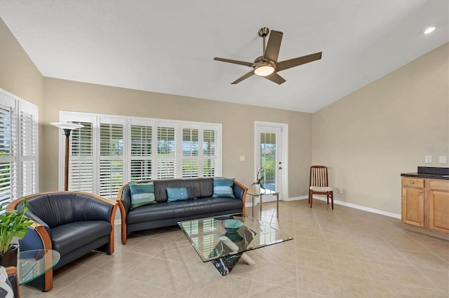 living room featuring light tile patterned floors, ceiling fan, baseboards, and vaulted ceiling