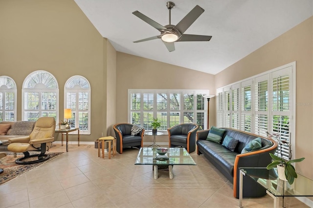 interior space with light tile patterned floors, baseboards, high vaulted ceiling, and a ceiling fan