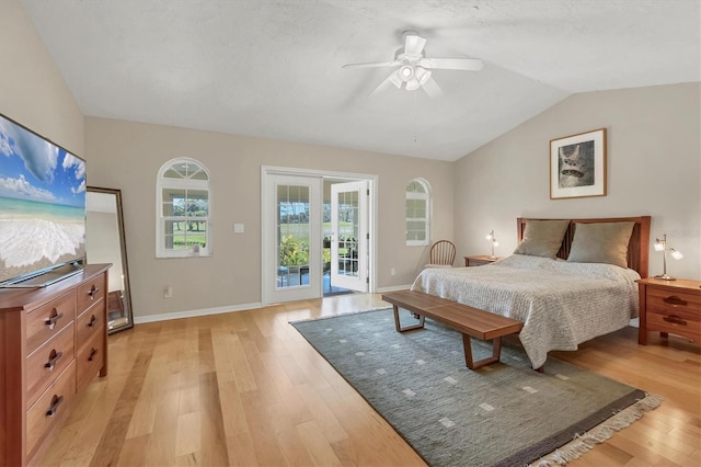 bedroom featuring access to exterior, baseboards, vaulted ceiling, and light wood-style floors