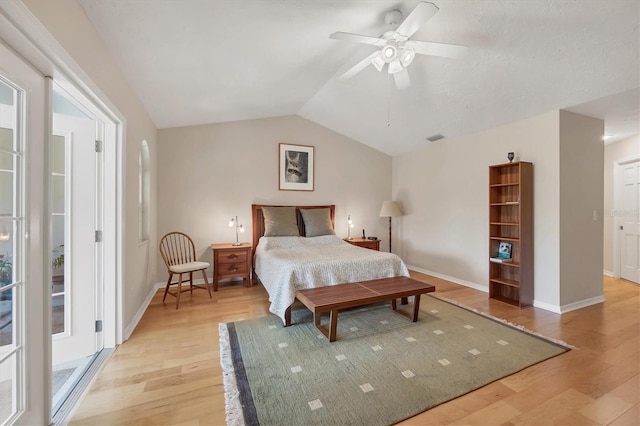 bedroom featuring lofted ceiling, light wood-type flooring, visible vents, and baseboards