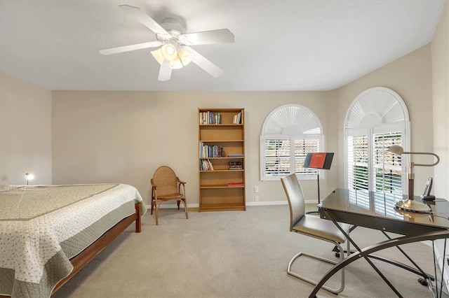 bedroom with ceiling fan, baseboards, and light colored carpet