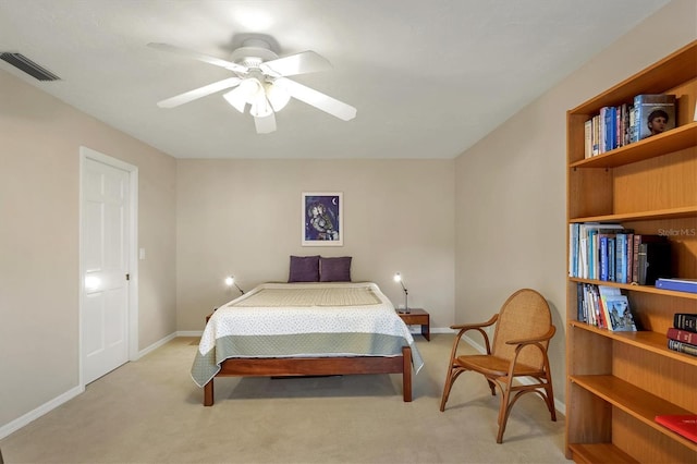 bedroom featuring baseboards, visible vents, and light colored carpet