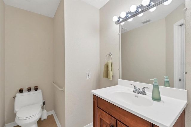 bathroom featuring baseboards, visible vents, vanity, and toilet