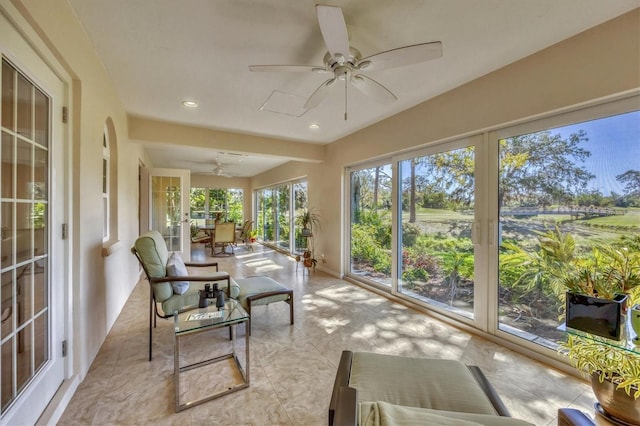 sunroom / solarium featuring ceiling fan