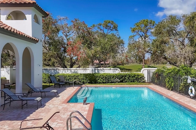 view of pool with a patio area, fence, and a fenced in pool