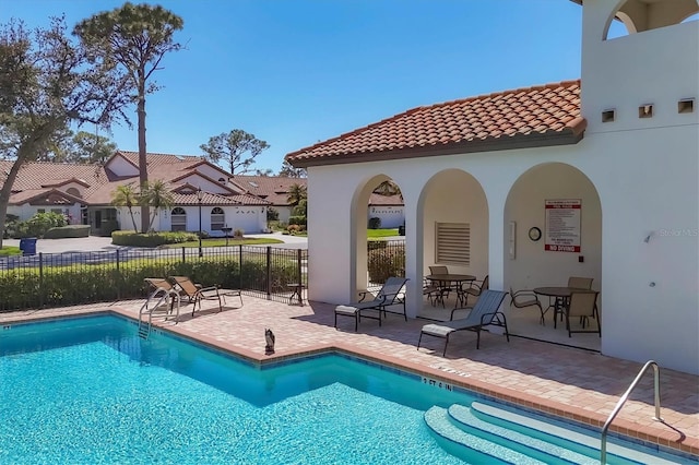 pool featuring a patio and fence