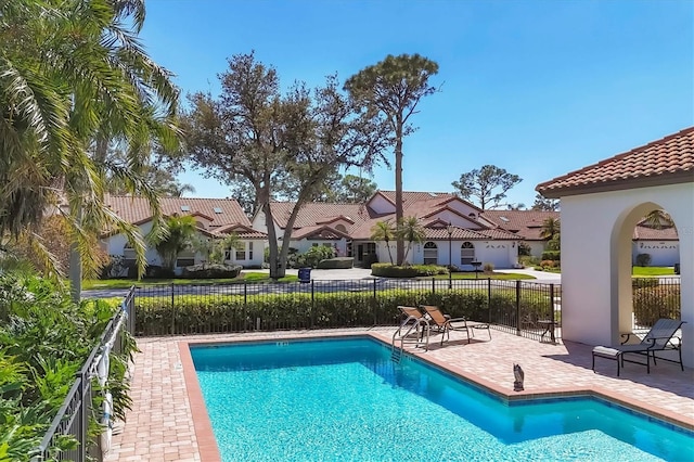 view of swimming pool featuring a fenced in pool, a patio area, and fence