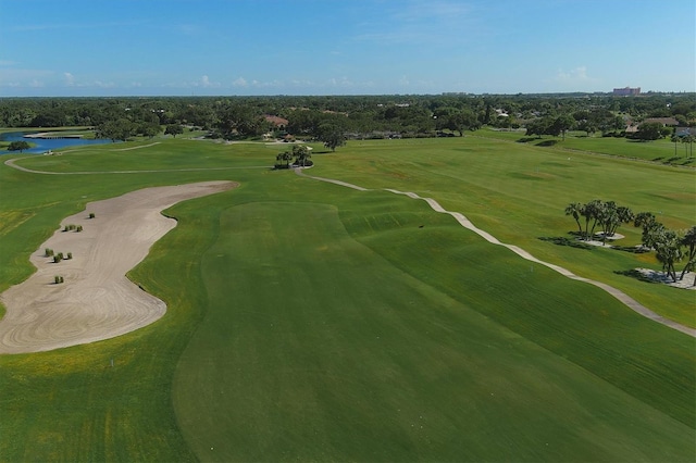 drone / aerial view featuring view of golf course and a water view