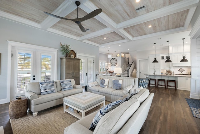 living area with visible vents, coffered ceiling, dark wood finished floors, beamed ceiling, and stairs